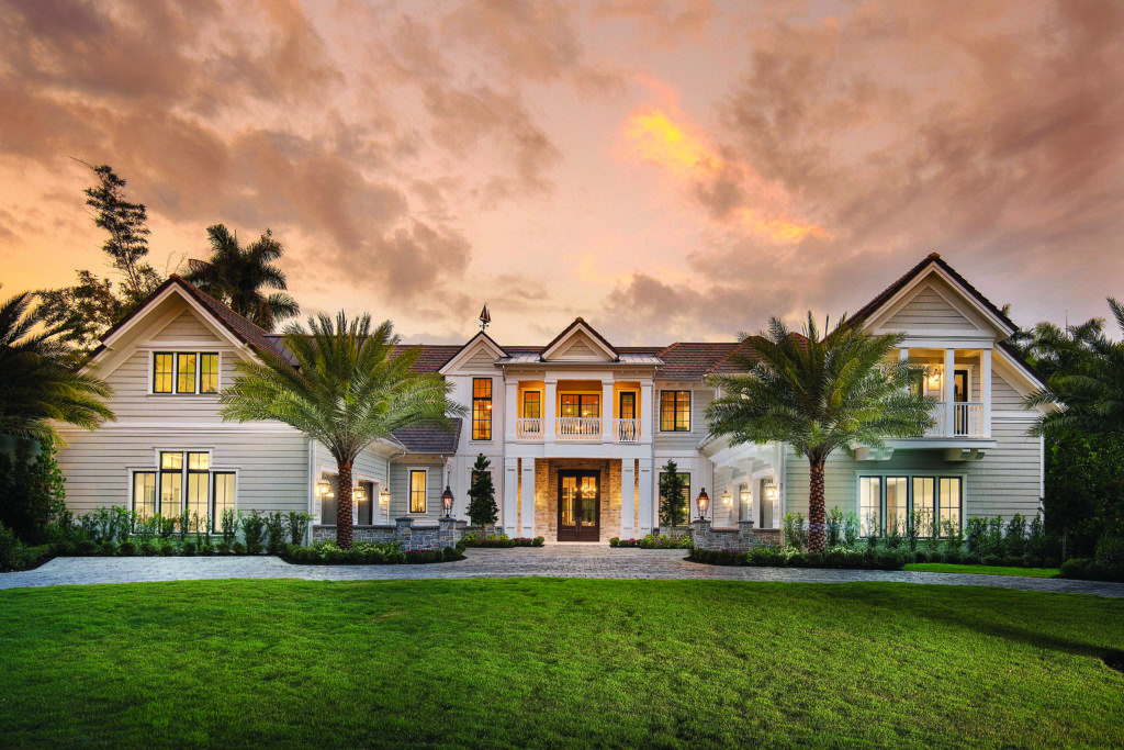 Ten-foot-high mahogany doors, a portico and a large circular driveway charm in this Coquina Sands home.