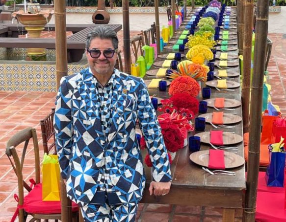 Wilfredo Emanuel in front of a colorful tablescape