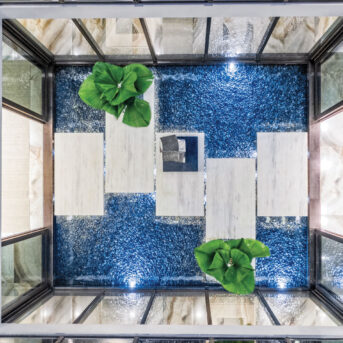 Aerial view of an indoor pool with walkway