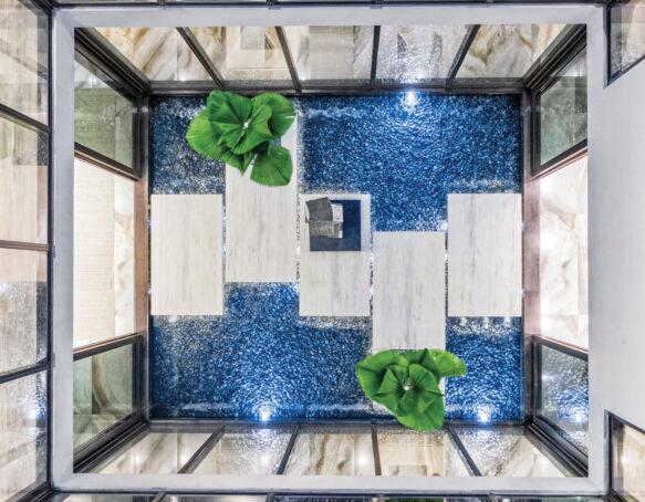 Aerial view of an indoor pool with walkway